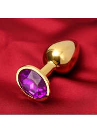 Золотистая анальная пробка с фиолетовым кристаллом - Сима-Ленд - купить с доставкой в Москве